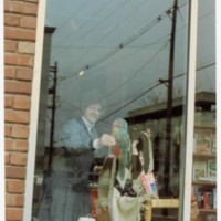 Photograph of Bernadette Traiger Creating Raven Bookstore Window Display, 1990.